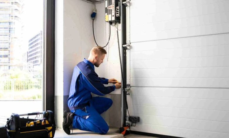 Homeowner placing wooden test block under garage door to test auto-reverse contact safety feature during monthly maintenance check