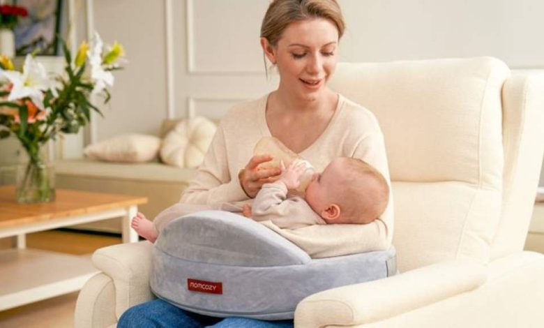 A new mother using ergonomic nursing support with a memory foam pillow during a comfortable breastfeeding session in a cozy chair.