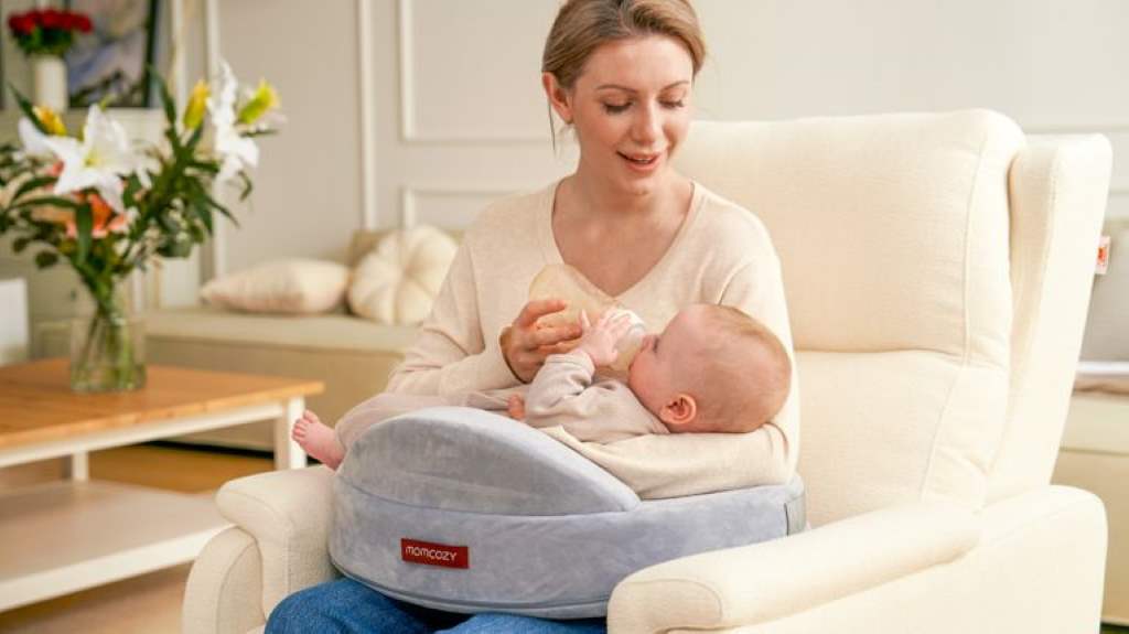 A new mother using ergonomic nursing support with a memory foam pillow during a comfortable breastfeeding session in a cozy chair.