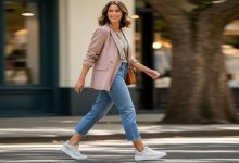 Woman wearing stylish wide toe box sneakers with cropped jeans and blazer for casual comfort