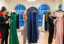 Fashion boutique tailor adjusting long evening dress in New York