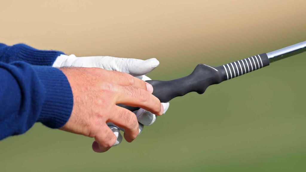 Beginner golfer improving swing accuracy with basic training equipment