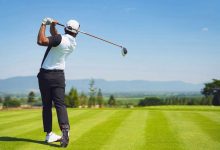 Golfer practicing accuracy with simple golf training aids on range