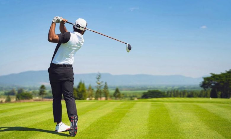 Golfer practicing accuracy with simple golf training aids on range