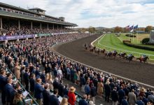 Thousands of racing fans in business formal attire watching Thoroughbred horses compete on the dirt track at Keeneland Race Course during the Breeders Cup 2026 on October 31