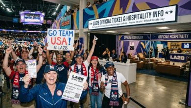 Fans celebrating inside an LA28 Olympics venue with ticket and hospitality information